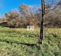 Extensive residential plots in Bytča, surrounded by trees with a property in the background.