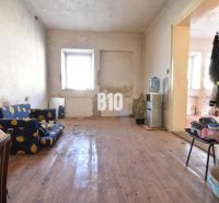 Living room in a family house with a wooden decor floor, older furniture.