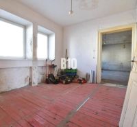 A room in a family house with a red floor and windows, Bytča.