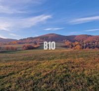 The picture shows an autumn landscape with a meadow and hills suitable for plots and living.