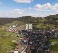 An aerial view of picturesque plots in Bytča surrounded by greenery and houses.