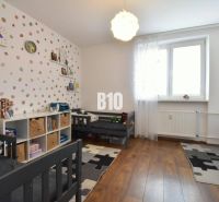 A children's room with a wooden decor floor in a 3-room apartment.