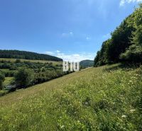 Hilly landscape with a meadow in Dolný Vadičov, ideal for residential plots.