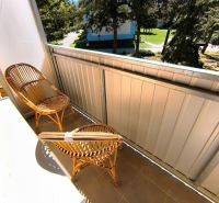 The balcony of a 1-room apartment on Malá Okružná in Partizánske with rattan seating.