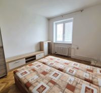 A room in a 3-room apartment with a double bed and a wooden decor floor.