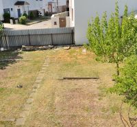 A garden behind a family house, with a lawn and trees on Nabr. J. M. Hurbana Street in Michalovce.
