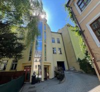 A building with a glass facade on a narrow street, Grösslingova, Bratislava - Old Town. Offices.