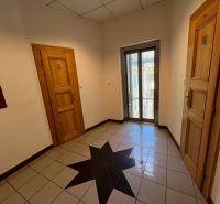 Offices with wooden doors, star-patterned tiles, and glass doors.