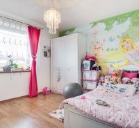 Children's room in a family house with princess decor and wooden floor decor.