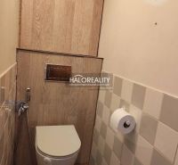 Bathroom in a 3-room apartment with a wooden decor floor and tiling.