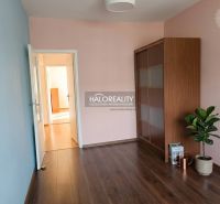 A room in a 3-room apartment with a wooden decor floor and a built-in wardrobe.
