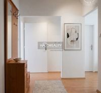 A hallway in a 3-room apartment with a wooden decor floor and modern furniture.