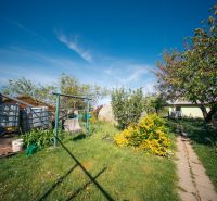 A garden at a family house in Golianovo on Golianovo street with trees and a lawn.