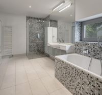 Bathroom with a bathtub, shower corner, and glass shelves in a 3-room apartment.