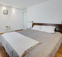 A bedroom in a 3-room apartment with a comfortable bed and a floor with a wooden decor.
