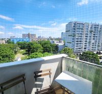 View from the balcony of greenery, tall buildings, and clear skies in Bratislava - Ružinov.