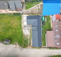 Aerial view of a family house in Stupno surrounded by a grassy plot and neighboring buildings.