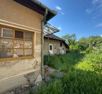 A family house in Bánov with a neglected garden and an older facade on Bánovská Street.