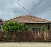 A family house in Bánov on Bánov Street with a brick roof and fence.
