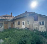 Older family house in Bánov on Bánov Street with a sunny garden and grassy plot.