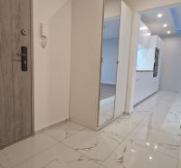 Entrance hallway in a 2-room apartment with ceramic flooring and a built-in wardrobe.