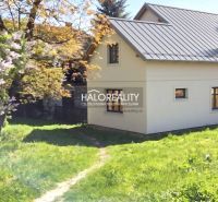 A family house in Poltár with a garden, surrounded by greenery and flowers.