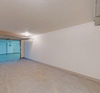 Garages with open doors, white walls, and floors in Bratislava - Petržalka.
