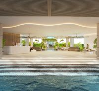 Interior of residential development with a reception and relaxation area, decorated with greenery and seating.