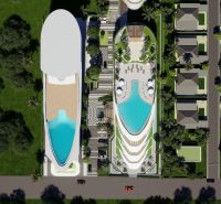 Aerial view of apartment construction in Phuket with a pool and villas.