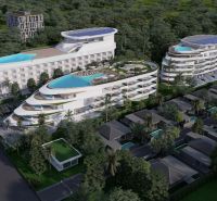 Apartment construction in Phuket with a wavy design and rooftop pools set in greenery.