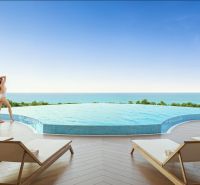 A pool with a sea view and sun loungers, Apartment construction in Phuket.