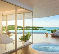 Elegant interior with a view of the terrace, pool, and ocean, Apartment construction.