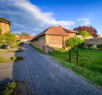 A stone pathway running alongside a historic building in the Grounds - commercial in Fiľakovo.