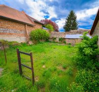 Lands - commercial in Fiľakovo, enclosed area with grass and stone buildings.