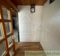 Interior with a wooden ceiling, doors with glass, and a floor with a wooden decor in a family house.