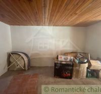 Basement of a family house with a wooden ceiling and stored boxes.