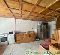 Kitchen space in a family house with a wooden ceiling and appliances.