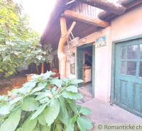 An old family house in Gbelce with a wooden veranda and green doors.
