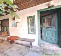 Old wooden door and a bench in the yard of a family house in Gbelce.