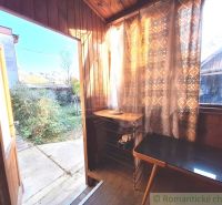 Interior of a family house with a wooden decor floor and a view of the garden.