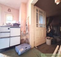 The interior of a family house with a vintage stove and old doors with glass panels.