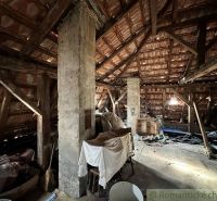 Attic in a family house with visible wooden beams and storage spaces.