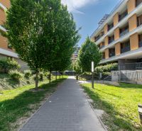 Bajkalská Street in Bratislava with apartment buildings and trees along the sidewalk.