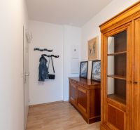 Interior of a 2-room apartment with wooden furniture and flooring with a wooden decor.