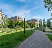 Buildings surrounded by greenery and a walkway on Bajkalská in Bratislava, suitable for a 2-room apartment.