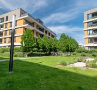 Residential complex on Bajkalská Street in Bratislava, with greenery and benches in the courtyard.