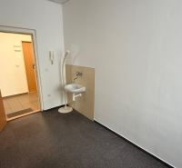 Offices with carpet, sink, and white walls.