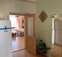 Interior of a 2-room apartment with a wooden decor floor, visible living room.