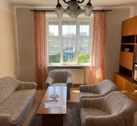 Living room in a two-room apartment with a sofa, armchairs, TV, and furniture.