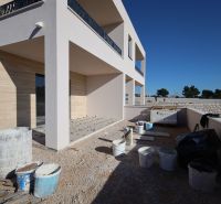 A recreational apartment in Vodice under construction, with a terrace and building materials around.